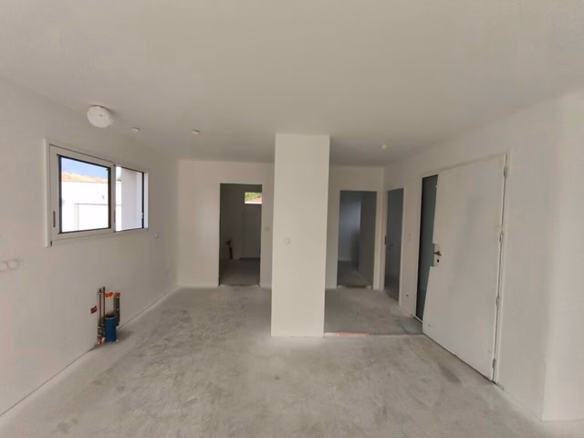 Intérieur maison neuve avec murs peints en blanc (couche d'impression) et portes posées