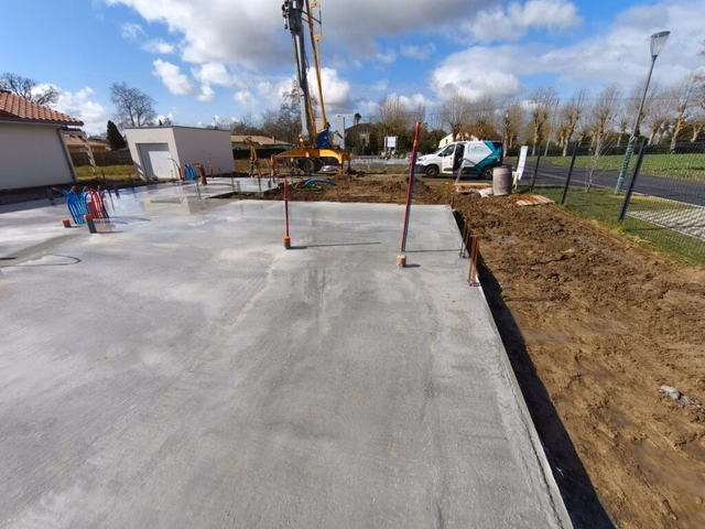 Dalle de compression en béton fraîchement coulée sur le chantier de construction à Saubrigues